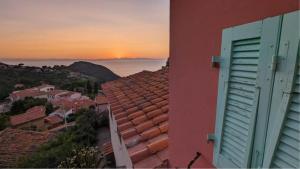 Blick auf das Meer von einem Gebäude mit Sonnenuntergang in der Unterkunft Il Plumbago - Elba Affitti in Mortigliano