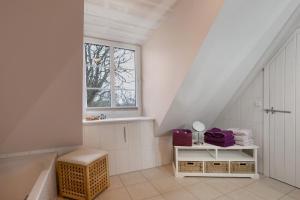 a bathroom with a bath tub and a window at Fewo Kastanienhof in Pellworm +123 photos