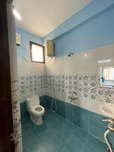 a bathroom with a toilet and a sink at Kutir Stay in Secunderabad +28 photos
