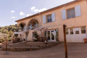 a large house with a balcony and a patio at NOUS in Agel