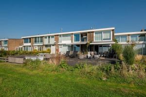 a large building with a lawn in front of it at Villa Present - Vakantiewoning Kamperland VP054 in Kamperland