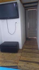 a flat screen tv on a wall in a room at Glamping en villa 2 in Villa de Leyva