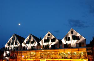 a building with three pointed roofs with the moon in the sky at Hotel an der Stadtmauer in Schorndorf