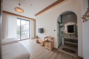 TV a/nebo společenská místnost v ubytování Meizhou Island Lijia Xiaoyuan B&B