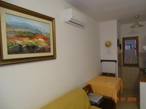 a living room with a couch and a painting on the wall at Guest House AB Adria Home in Rovinj