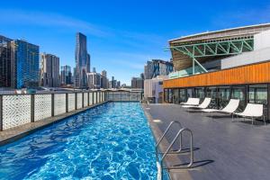 The swimming pool at or close to Chic 1-Bed with Harbour Views & Pool by Tram Line