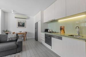 A kitchen or kitchenette at Chic 1-Bed with Harbour Views & Pool by Tram Line