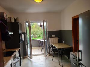 a kitchen with a table and a table and a door at Ihr Zuhause auf Zeit in Düren - Eifel