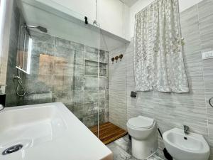 a bathroom with a tub and a toilet and a sink at Luxury Centre, Cagliari, Sardegna by Home&Experience in Cagliari