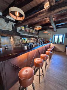 a bar with brown stools in a restaurant at Eguen Goiko in Lekeitio