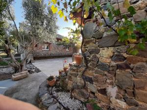 a stone building with a stone wall at Mas des Olivettes in Montauriol