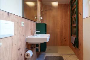 a bathroom with a sink and a mirror at Ferienwohnung Spielzeughof in Seiffen +6 photos
