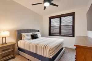 a bedroom with a bed and a ceiling fan at Luxury Downtown Rental - La Dolce Vita Villas #2 in Moab