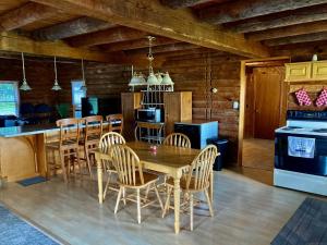 a kitchen and dining room with a table and chairs at Garden Grove Retreat & Lodging near Pictured Rocks, Fayette, Trails in Garden