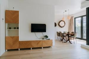 a living room with a tv on a white wall at 2 bedroom apartment and private parking in Liège center in Liège
