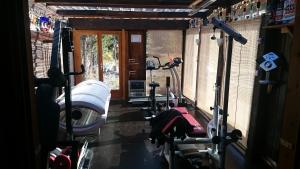 a gym with two treadmills in a room at Chalet Espace Lumière - Spa, sauna et salle de fitness in Méolans