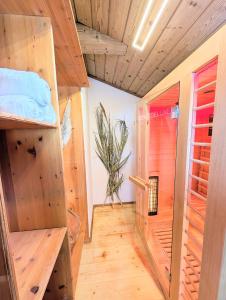 a room with wooden floors and a room with a glass door at Neu! Moderner bayrischer Flair vor Pilatushaus in Oberammergau +59 photos