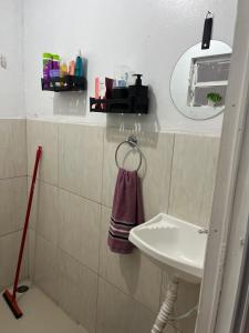 a bathroom with a sink and a mirror at Apartamento centro garanhuns 3 quartos in Garanhuns