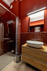 a bathroom with a sink and a shower at Red Suite - City center & Garage in Parma +13 photos