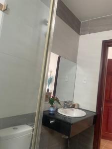 a bathroom with a sink and a mirror at K HO DISCOVERY Guest House in Da Lat +42 photos