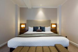 a large white bed in a hotel room at Thistle London Piccadilly in London