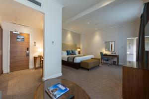 a hotel room with a bed and a table at Thistle London Piccadilly in London