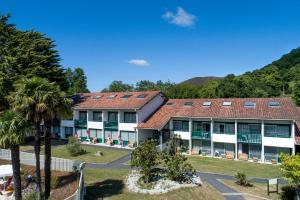 an exterior view of a resort with mountains in the background at Village Club Le Saint Ignace in Ascain