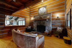 a living room with a stone fireplace and a couch at Goldilocks in Canton