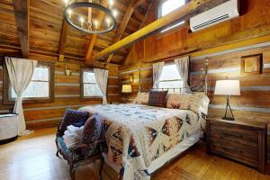 a bedroom with a bed in a room with wooden walls at Goldilocks in Canton