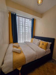 Postel nebo postele na pokoji v ubytování Nyumbani Vibes - Treands Apartment