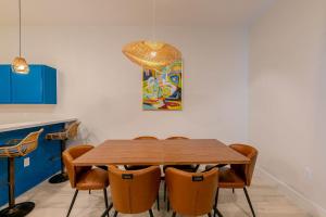 a dining room with a wooden table and chairs at Sandbar Serenade in South Padre Island