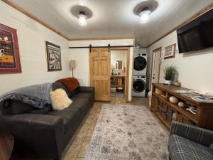 a living room with a couch and a tv at Homestead Haven in Franklinton
