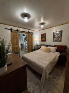a bedroom with a bed and a desk and a table sidx sidx sidx at Homestead Haven in Franklinton