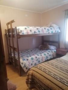 a bedroom with two bunk beds and a bed at Cisnes del tolten in Freire