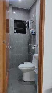 a small bathroom with a toilet and a shower at 2 Bedroom 2 Storey Near Robinsons Marasbas in Caiba-an