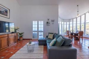 a living room with a couch and a table at Casa Almada in Ribeira Brava