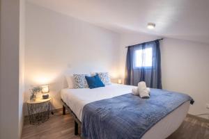a bedroom with a large bed and a window at Casa Almada in Ribeira Brava
