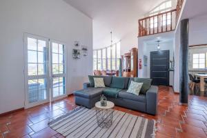 a living room with a couch and a table at Casa Almada in Ribeira Brava
