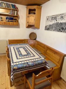 a dining room with a table with a quilt on it at Holiday house Pr Robč in Bovec