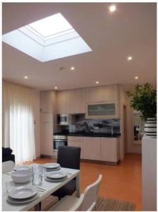 a kitchen with a table with plates on it at Beach Bungalows - Casal dos Patos - Villa Sul in Lourinhã