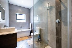 a bathroom with a sink and a toilet and a shower at Phoenix Home in Cape Town +65 photos