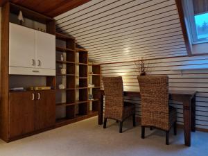 a dining room with a table and two chairs at Marburg Apartment geräumiger Lukas in ruhiger Waldrandlage mit Wintergarten in Marburg an der Lahn +19 photos