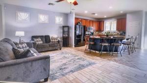 a living room with two couches and a kitchen at Pet friendly 3br 2ba Private optional heated Pool BBQ grill Golf Clubs close to park in Casa Grande