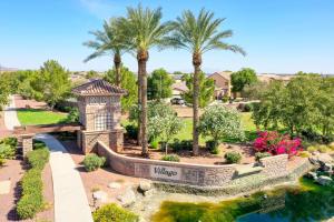 an aerial view of a villa with a pond and palm trees at Pet friendly 3br 2ba Private optional heated Pool BBQ grill Golf Clubs close to park in Casa Grande