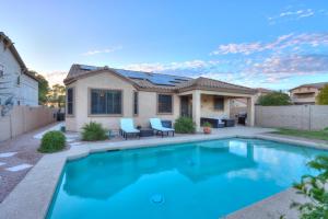 a swimming pool in front of a house at Pet friendly 3br 2ba Private optional heated Pool BBQ grill Golf Clubs close to park in Casa Grande