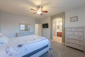 a bedroom with a bed and a ceiling fan at Pet friendly 3br 2ba Private optional heated Pool BBQ grill Golf Clubs close to park in Casa Grande +41 photos
