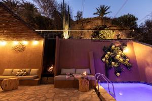 a swimming pool with a couch and a table next to it at Kuiseb House in Windhoek