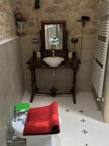 a bathroom with a sink and a toilet and a mirror at Casa Vacanza Abruzzo 06804dueAFFzerozerozerodue in Caramanico Terme
