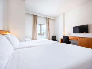 Postel nebo postele na pokoji v ubytování Hotel Zentral León