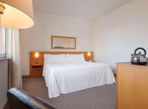 Postel nebo postele na pokoji v ubytování Hotel Zentral León